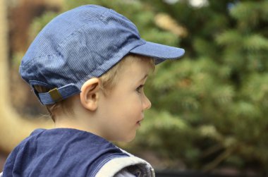 Portrait a little boy who looks curiously at the world clipart