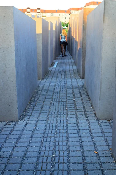 Girl in concrete corridor