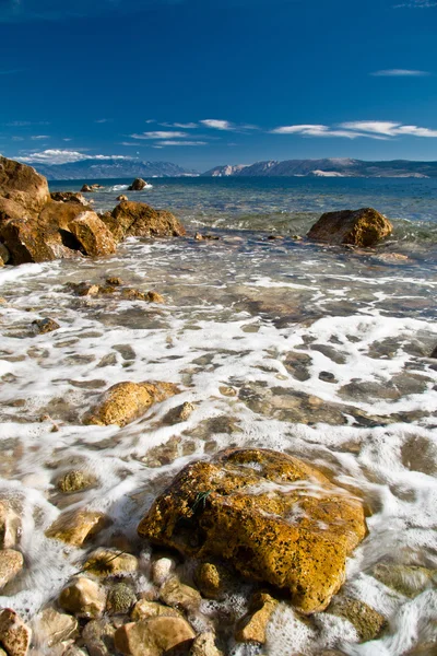 Stock image Stones in sea uder blue sky