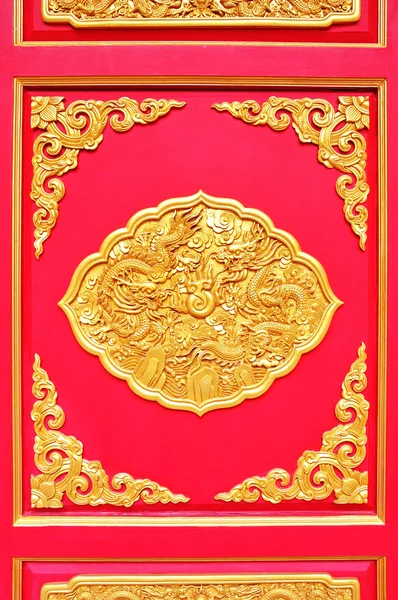 Golden dragon decorated on red wood — Stock Photo, Image