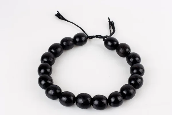 Round black beads on white background — Stock Photo, Image