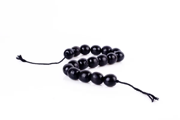 Perles rondes noires sur fond blanc Photos De Stock Libres De Droits