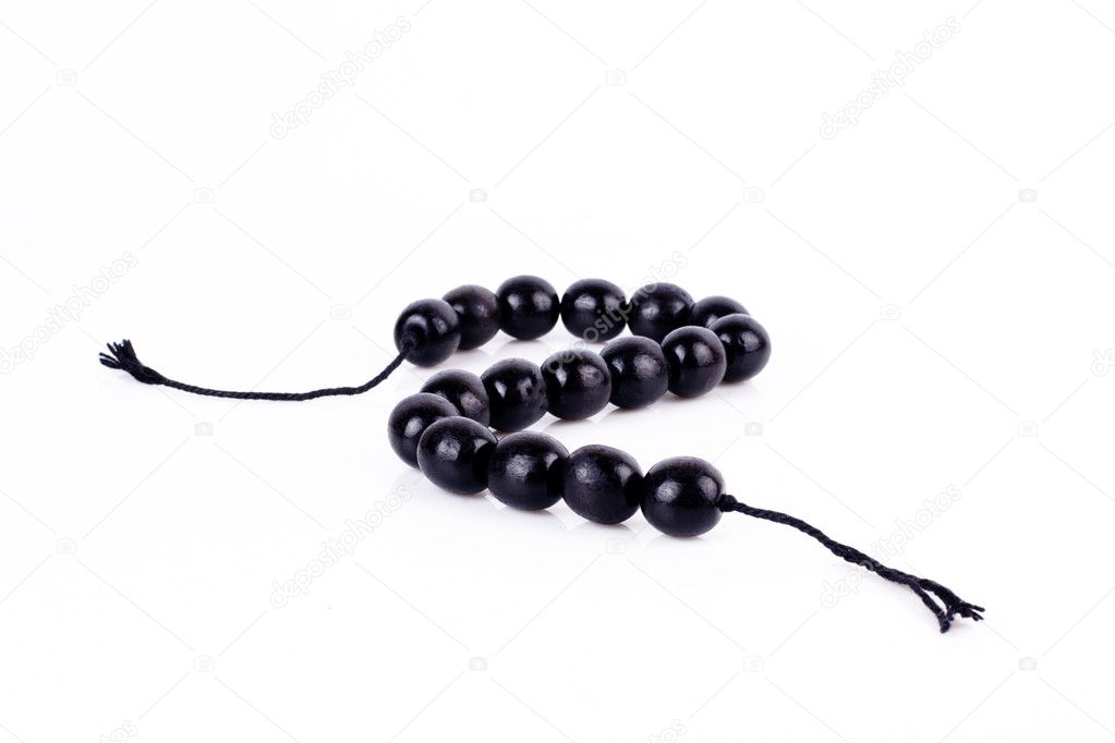 Round black beads on white background