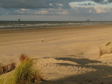 North sea beach in the sunset on the island ameland in holland clipart