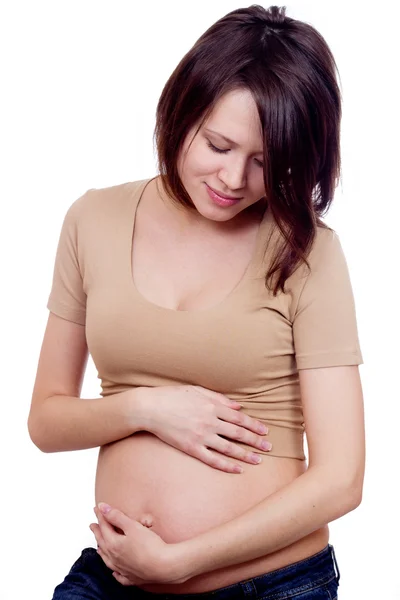 Beautiful pregnant woman touching her belly with her hands — Stock Photo, Image