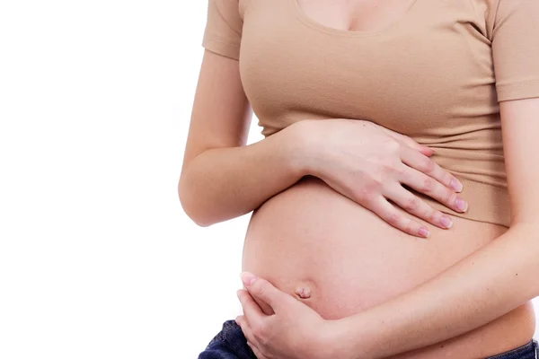 Pregnant woman touching her belly with her hands — Stock Photo, Image