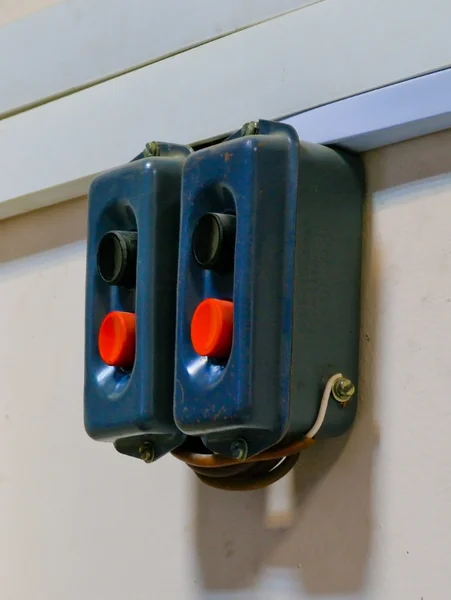 stock image Couple of old dirty switches with black and red buttons