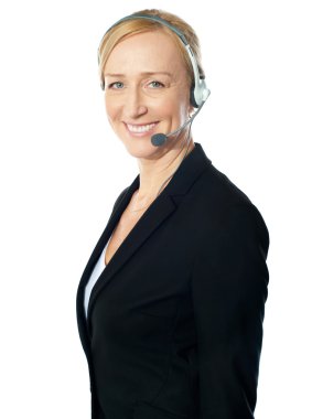 Aged female call centre excutive posing with headsets clipart