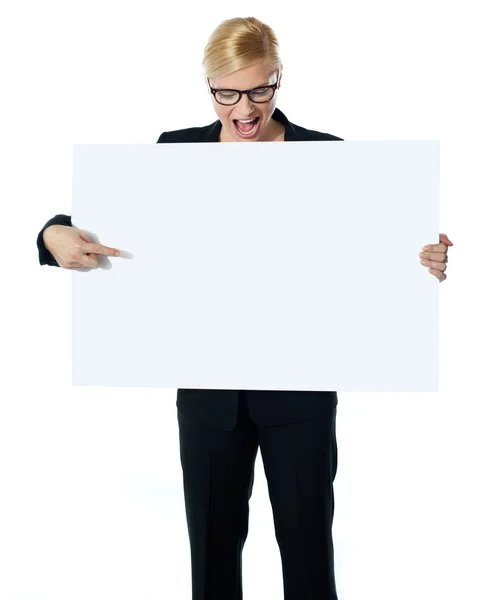 Erfolgreiche Geschäftsfrau zeigt auf weiße Plakatwand — Stockfoto