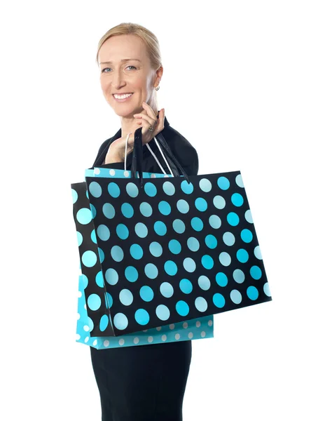 Senior woman posing with dotted shopping bag — Stock Photo, Image