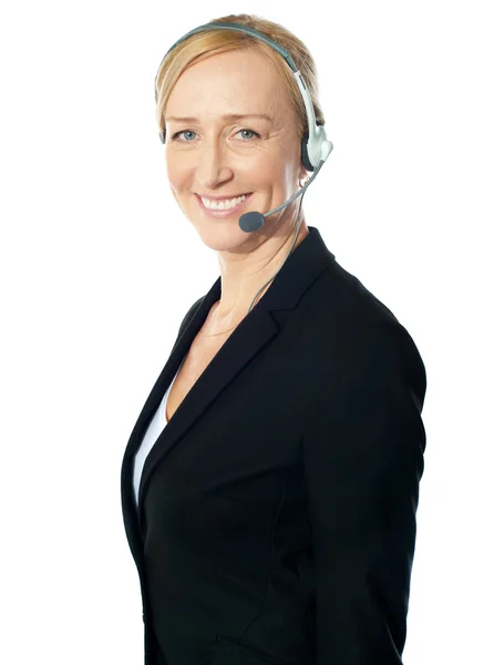 Aged female call centre excutive posing with headsets — Stock Photo, Image