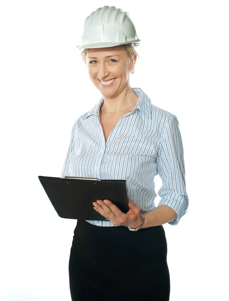 Smiling female architect holding documents — Stock Photo, Image