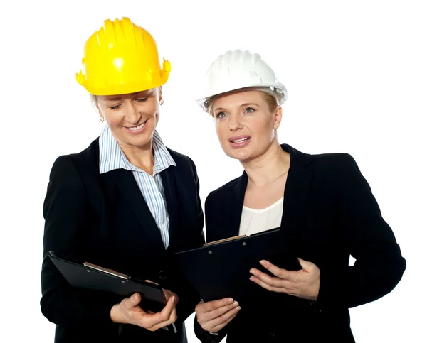 Young female architects reviewing documents — Stock Photo, Image