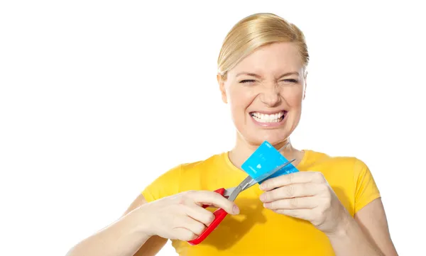 stock image Woman grinding teeth while cutting her credit card