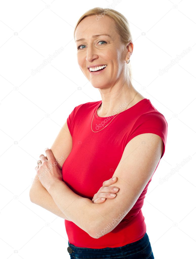 Smiling middle aged lady, poisng with folded arms