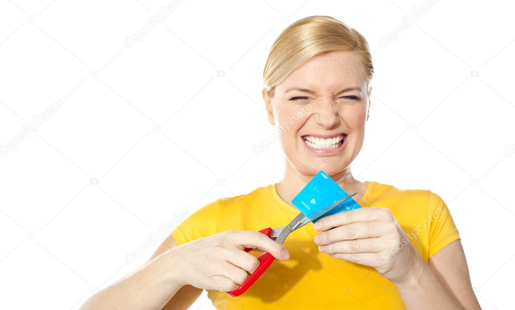 Woman grinding teeth while cutting her credit card