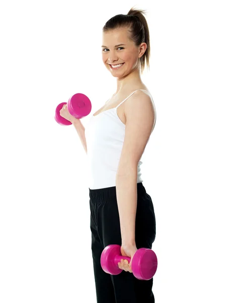 Strong teenager working out with dumbbells — Stock Photo, Image