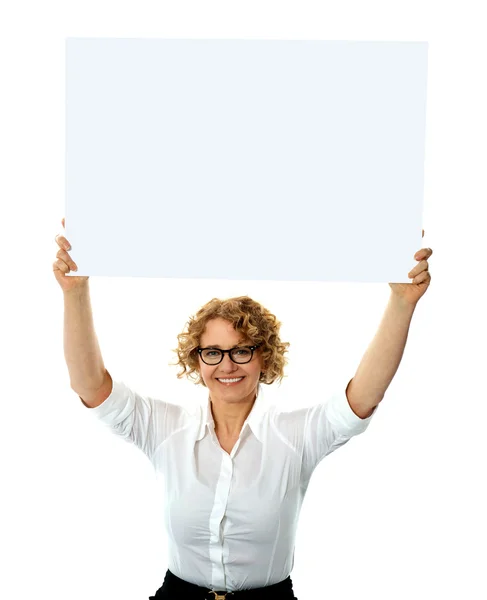Happy woman holding blank billboard — Stock Photo, Image