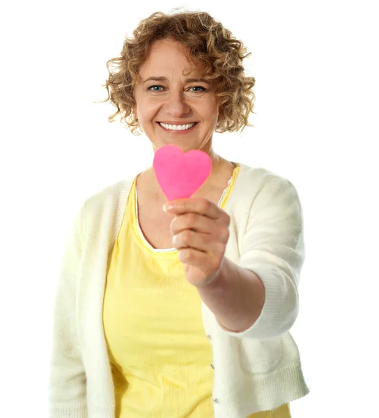 Happy woman offering her heart — Stock Photo, Image