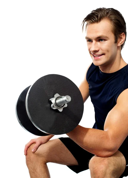Strong young man working out with dumbbells — Stock Photo, Image