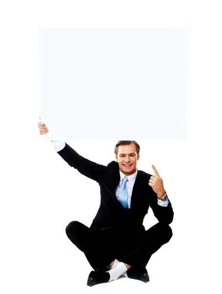 Business professional pointing up towards blank placard — Stock Photo, Image