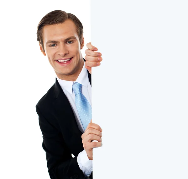 Smiling business professional behind blank clipboard — Stock Photo, Image