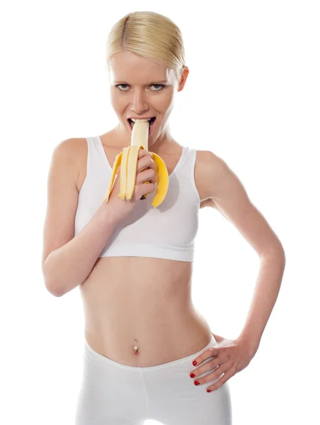 Hungernde sexy Frau isst Banane — Stockfoto