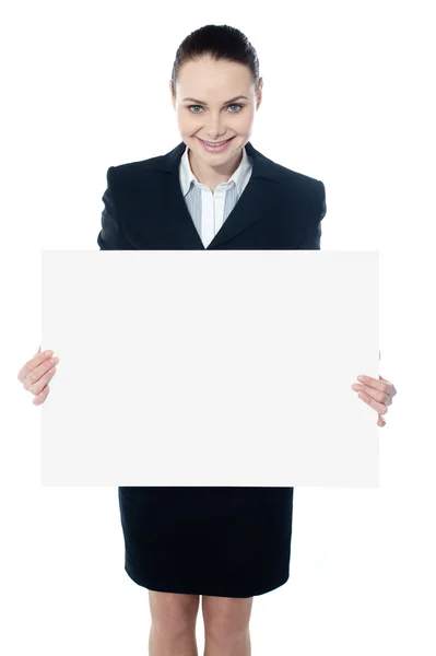 Female executive showing blank billboard to camera — Stock Photo, Image