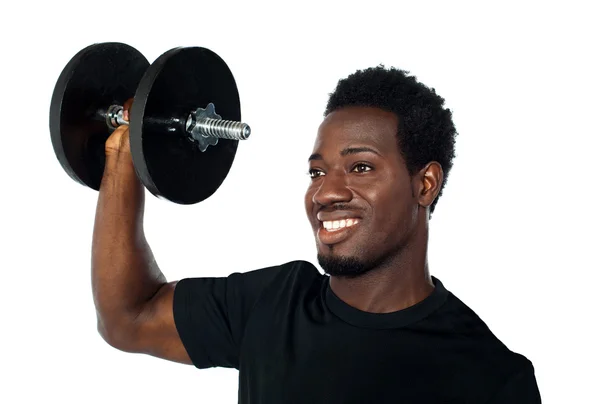 Powerful muscular young man lifting weights — Stock Photo, Image