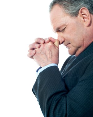 Portrait of matured businessman praying clipart