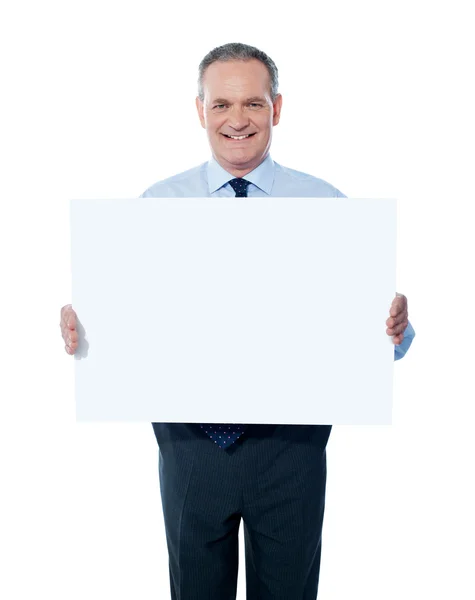 Handsome man holding blank white billboard — Stock Photo, Image