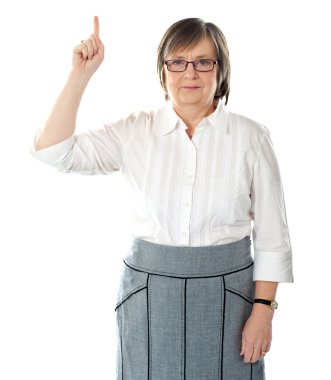 Beautiful senior business lady pointing upwards clipart