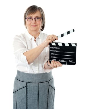 Attractive senior woman using clapperboard clipart