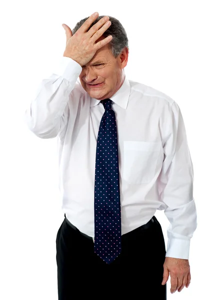 Sad old corporate man with hand on head — Stock Photo, Image