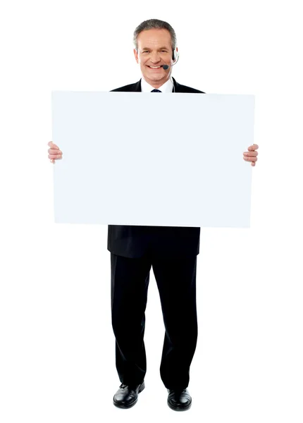 Businessman holding a blank billboard — Stock Photo, Image