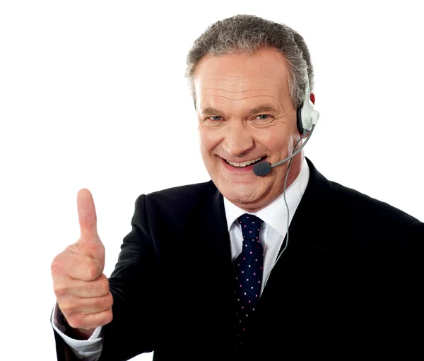 Call centre executive smiling with thumbs-up — Stock Photo, Image