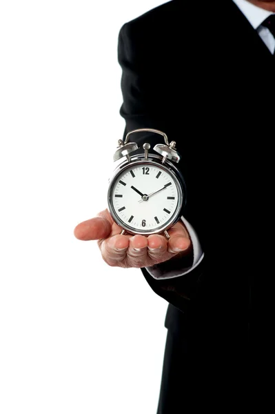 Cropped image of a man with alarm clock on his palm — Stock Photo, Image