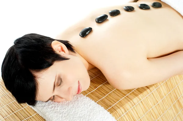 Woman getting spa treatment with hot stone — Stock Photo, Image