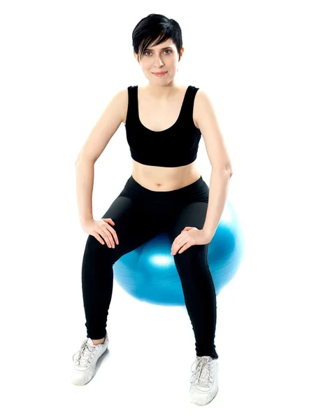 Fitness-Frau sitzt isoliert auf Pilateball — Stockfoto