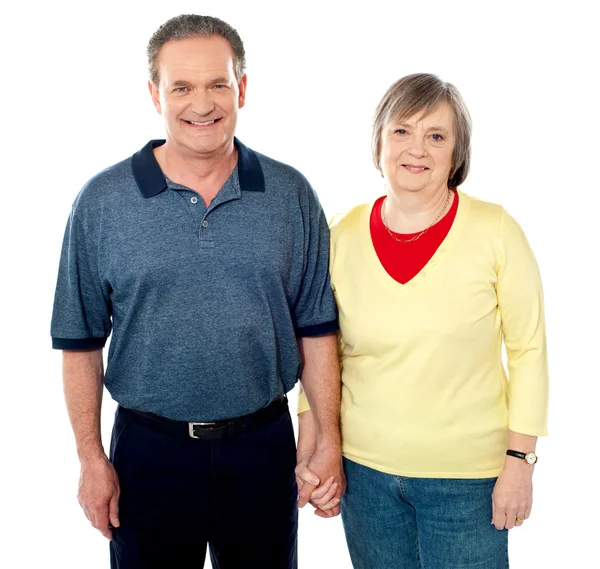 Loving senior couple posing with hand in hand — Stock Photo, Image