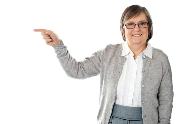 Portrait of beautiful aged woman pointing — Stock Photo, Image