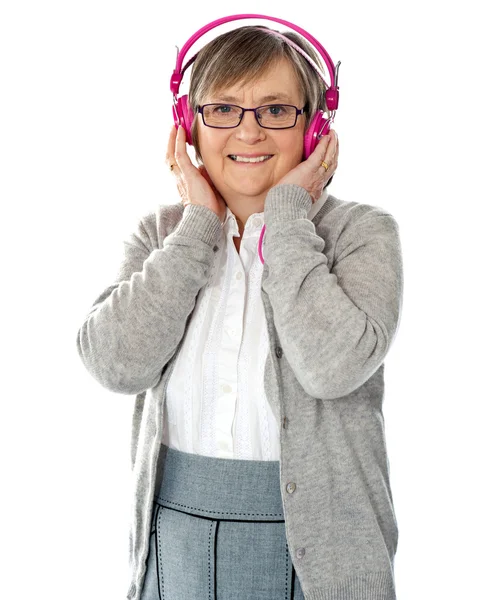 Attractive old lady wearing headphones — Stock Photo, Image