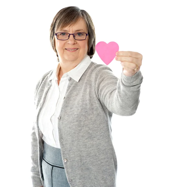 Female holding a pink paper heart — Stock Photo, Image