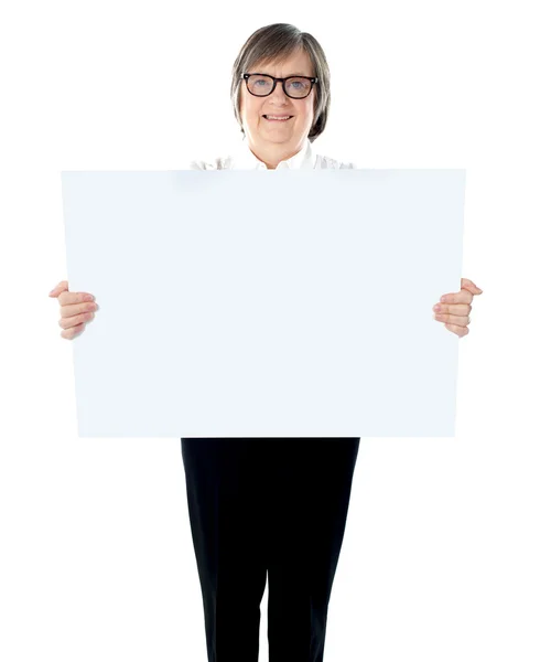 Senior businesswoman posing with blank placard — Stock Photo, Image