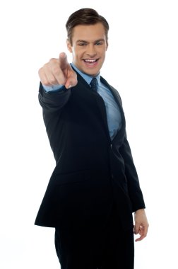 Smiling young professional pointing at you clipart