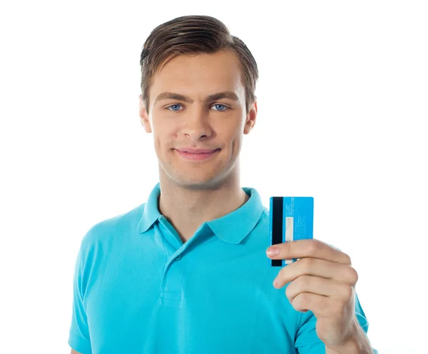 Close-up of handsome guy holding a credit card — Stock Photo, Image