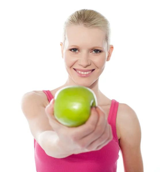 Healthy teenager offering green apple to you — Stock Photo, Image