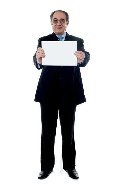 Senior business professional holding blank billboard — Stock Photo, Image