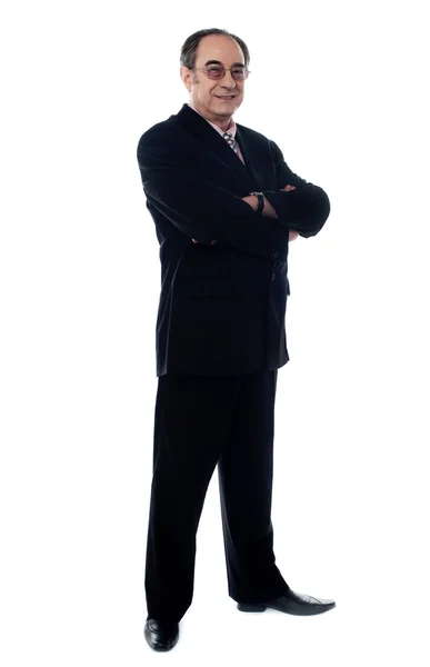 Handsome old manager standing with arms crossed — Stock Photo, Image