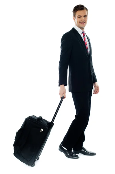 Handsome businessman dragging trolley bag — Stock Photo, Image